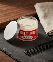 Royal Crown Pomade - pot ouvert sur une ardoise avec un peigne, la pommade blanc crème visible